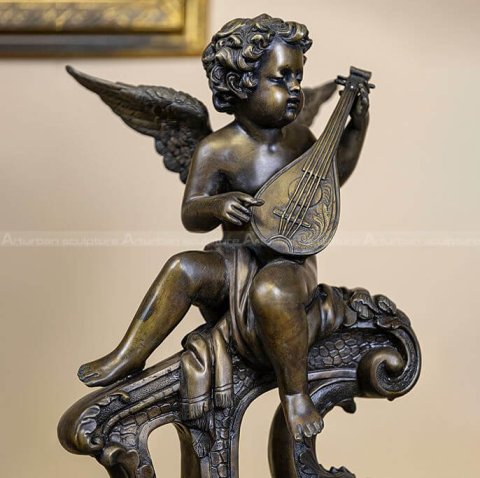 bronze cherub playing guitar statue