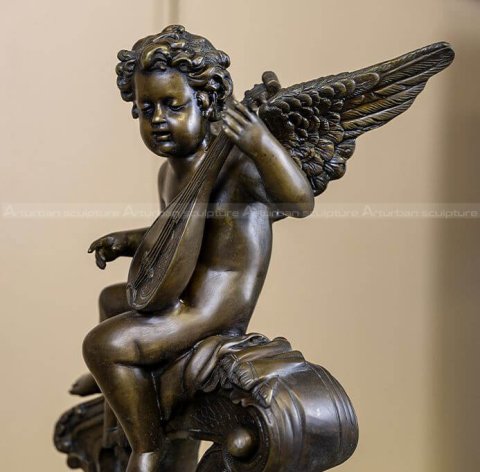 Cupid playing guitar statue